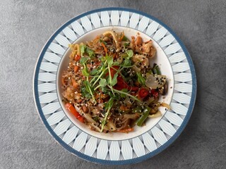 Asian glass noodle salad with vegetables and sesame seeds