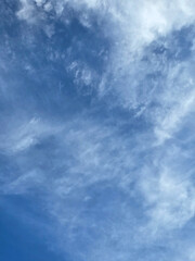 Blue Sky with White Fluffy Clouds. Natural Background for Weather, Nature, and Travel Concepts. High resolution sky texture wallpaper. Clear sunny morning sky.
