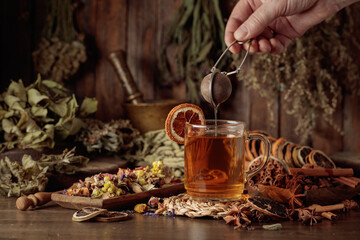 Cup of herbal tea with various dried herbs, flowers, and spices.