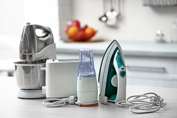 Household and kitchen appliances on the table in kitchen