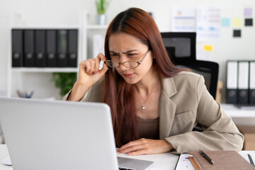 Businessman wearing glasses working diligently on business documents in the office.