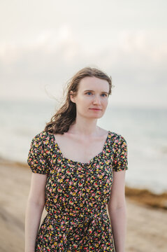 Young woman looking forlorn on beach