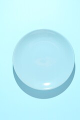 One stylish plate on light blue background, top view
