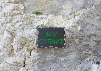 New Customer symbol. Stone wall with words New Customer. Beautiful stone background. Business and New Customer concept. Copy space.