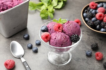 Delicious sorbet with fresh berries and mint in dessert bowl on grey textured table, closeup