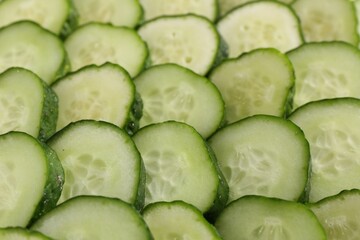 Slices of fresh cucumbers as background, closeup