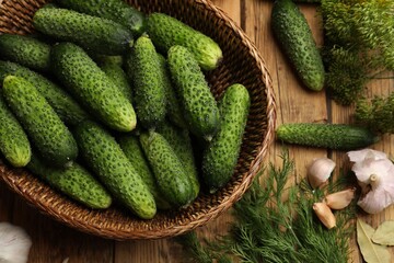 Making pickles. Fresh cucumbers and other ingredients on wooden table, flat lay