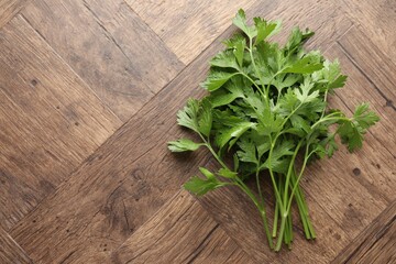 Fresh aromatic parsley on wooden table, top view. Space for text
