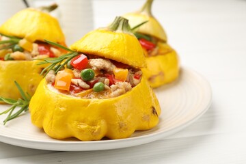 Tasty stuffed pattypan squashes on white wooden table, closeup