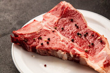 Raw steak T-bone fresh meat premium beef snack fresh delicious gourmet food background on the table rustic food top view copy space