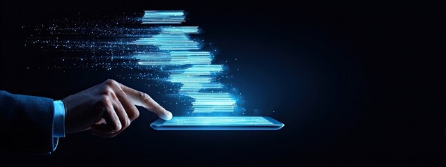 Hand interacting with a tablet displaying dynamic, light-blue data