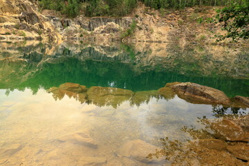 Limestone quarry lake. Turquoise water. Evening time in July. Nora, Bergslagen, Sweden.