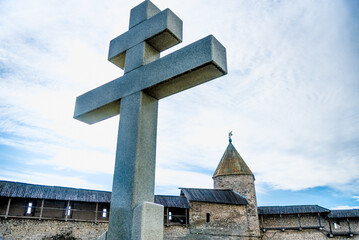Orthodox religious Christian large stone cross is installed outside church