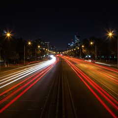 Nighttime urban street with streaks of traffic lights.