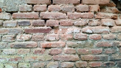 Rough-Hewn Red Brick Wall Texture, Close-Up Detail Emphasizing the Material's Strength and Durability for Construction or Industrial Themed Visuals