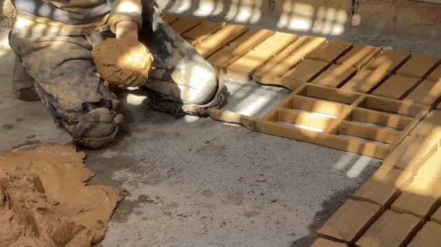 Closeup of Man Making Mud Bricks with a Mold