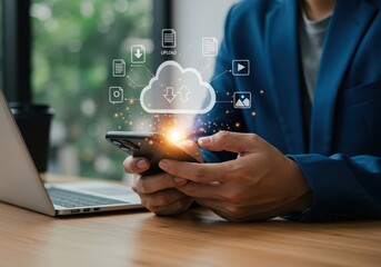 Person using cellphone with cloud computing icons and laptop on desk for data management solution