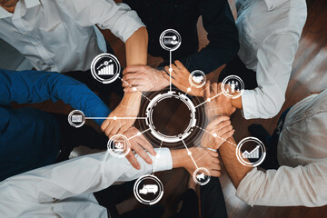 A diverse team engages in a collaborative strategy session, showcasing hands united in partnership. This image symbolizes teamwork and innovation in the business world. Amity