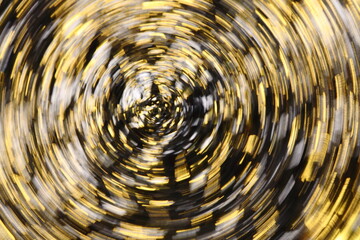 金色と黒と白の入り混じった同心円状の抽象模様