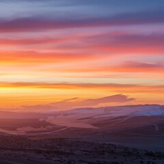 Obraz premium Vibrant Desert Sunset: Fiery Sky Over Rolling Dunes.