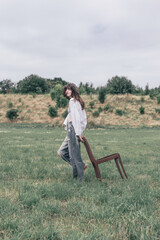 Woman enjoying peaceful walk in nature with chair