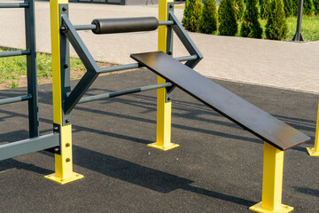 Outdoor fitness equipment featuring a bench for strength training in a public park