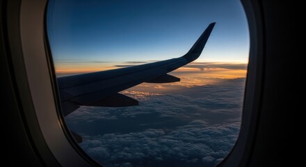 Sunrise view from airplane window above clouds