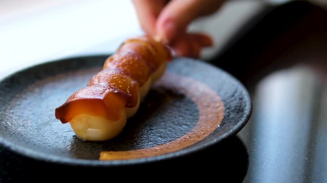 Dango rice cake with sweet soy sauce. Dango rolling on table. High quality 4k footage