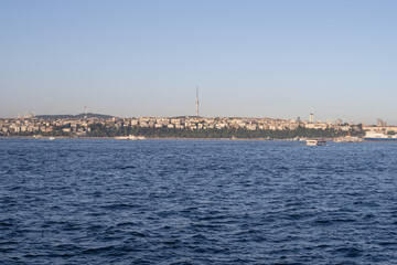 Fototapeta premium Scenic Bosphorus Strait in Istanbul at sunset with urban skyline, iconic bridges, fishing boats, and calm sea, highlighting the beauty and cultural heritage of Turkey’s most famous waterway