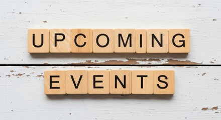 Wooden blocks spelling 'UPCOMING EVENTS' on a rustic white wood background, perfect for marketing