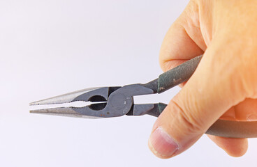 Hand holding electrical tools to assemble the electrical control panel. 