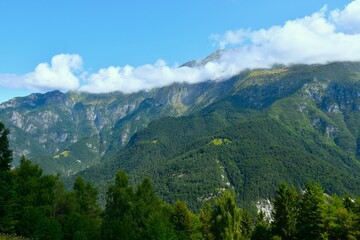 Obraz premium View of mountains in clouds in Kanin mountains above Resia in Friuli giulia, Italy