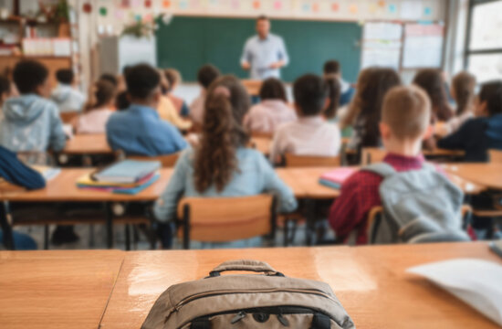 Classroom scene with students and teacher in the background.
