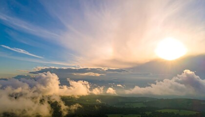 Scenic sunset view over a landscape of rolling hills and clouds.