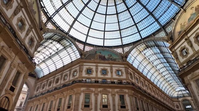 Soaring iron and glass dome of Galleria Vittorio Emanuele II in Milan, Lombardy, Italy crowns stately arcade