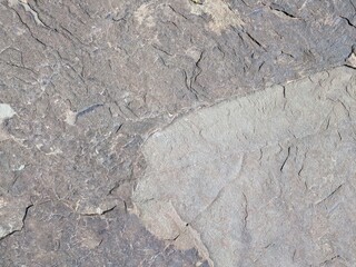 Natural brown stone texture with rugged patterns in bright daylight
