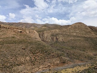 Mountainous terrain with rugged cliffs under a bright sky in Atlas Mountains