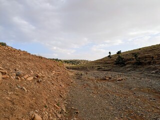 Dry landscape in the Atlas Mountains under a cloudy sky