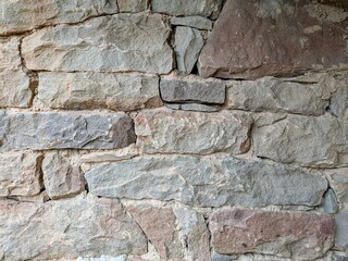Rugged stone wall showcasing natural colors and textures of stacked rocks