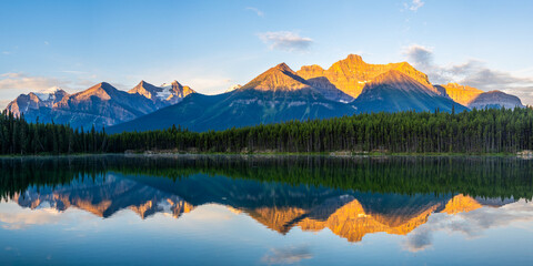 Golden sunrise reflection on Herbert Lake, Banff National Park