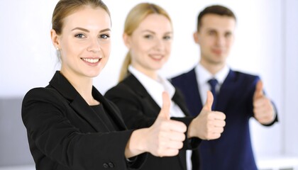 Business team giving thumbs up