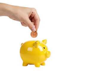 Saving money hand inserting coin into yellow piggy bank indoor bright setting perspective. Cut out png