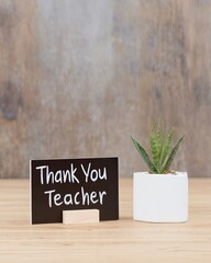 Thank You Teacher Sign With a Small Plant on a Wooden Table in a Cozy Setting