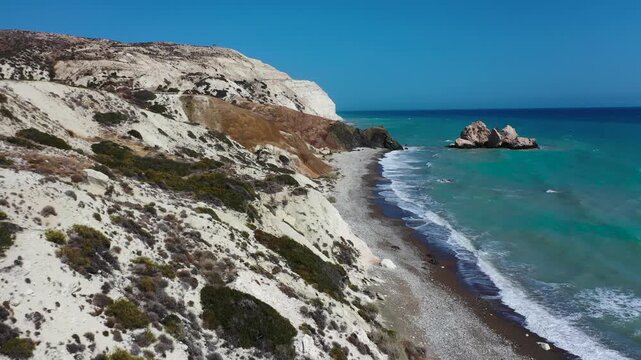 Aerial view of Adonis Rocks in Cyprus with waves crashing along rugged coastal cliffs