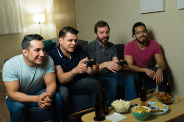 Group of friends playing video games and having fun at home