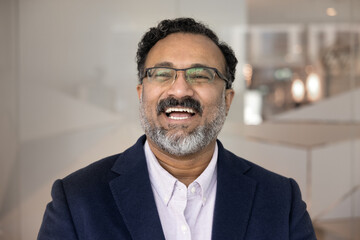 Leadership with confidence and joy. Headshot portrait happy mid aged man in formal suit motivated powerful business leader ceo executive laughing looking ahead visualize goals challenges enjoy success