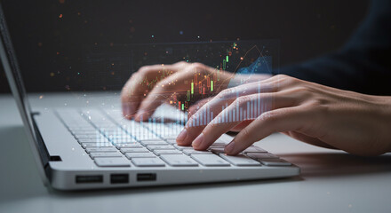 Closeup of hands typing on laptop with overlaid stock market graph and financial data visualization