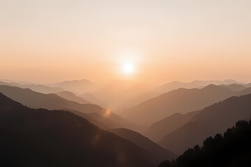 Fototapeta premium A sunrise over a foggy mountain range panorama
