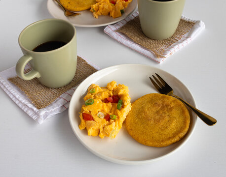 atin breakfast flat lay with scrambled eggs, arepa, and coffee &ndash; rustic food scene showcasing traditional flavors and cozy ambiance