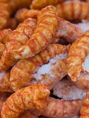 Rear view of a person wearing a virtual reality headset, reaching out with one hand as if interacting with a virtual environment. The individual has short blonde hair and is dressed in a blue and gree